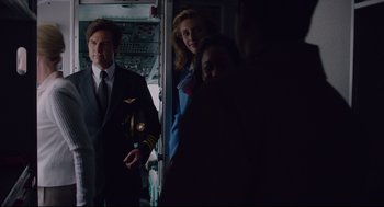 Movie still from “American Made” (2017), directed by Doug Liman – A group of people standing next to each other on a plane; Medium shot, Over the shoulder angle