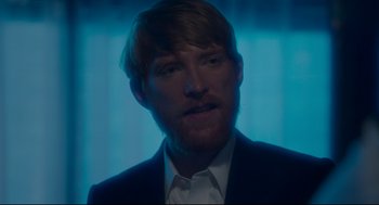 Movie still from “American Made” (2017), directed by Doug Liman – A person wearing a suit and tie; Close Up shot, Over the shoulder angle