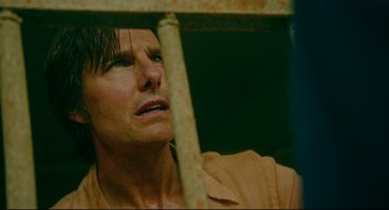 Movie still from “American Made” (2017), directed by Doug Liman – A person behind a metal fence; Close Up shot, Low angle