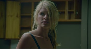 Movie still from “American Made” (2017), directed by Doug Liman – A woman with long blonde hair is looking at the camera; Close Up shot, Over the shoulder angle
