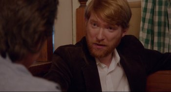 Movie still from “American Made” (2017), directed by Doug Liman – A person with a red beard; Close Up shot, Over the shoulder angle