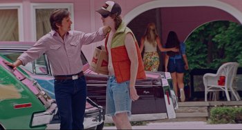 Movie still from “American Made” (2017), directed by Doug Liman – A man is talking to another man on the street; Medium shot, Over the shoulder angle