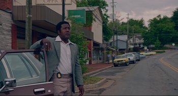Movie still from “American Made” (2017), directed by Doug Liman – A man standing on the side of the street; Medium shot, Low angle