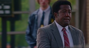 Movie still from “American Made” (2017), directed by Doug Liman – A man in a suit and tie sitting in front of another man in a suit; Close Up shot, Over the shoulder angle