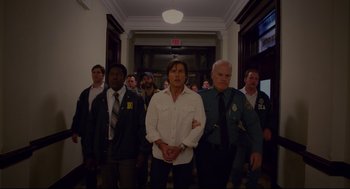 Movie still from “American Made” (2017), directed by Doug Liman – A group of men standing next to each other in a hallway; Medium shot, Low angle