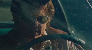 Movie still from “American Made” (2017), directed by Doug Liman – A person driving a car wearing sunglasses; Close Up shot, Over the shoulder angle