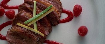 Movie still from “American Psycho” (2000), directed by Mary Harron – A plate of food on a table; Extreme Close Up shot, Overhead angle