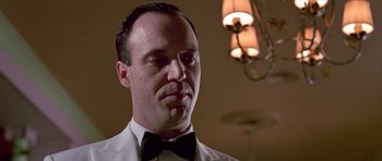 Movie still from “American Psycho” (2000), directed by Mary Harron – A person wearing a bow tie; Close Up shot, Low angle