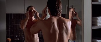 Movie still from “American Psycho” (2000), directed by Mary Harron – A man in the bathroom looking in the mirror; Medium shot, Low angle