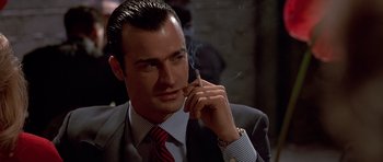 Movie still from “American Psycho” (2000), directed by Mary Harron – A person smoking a cigarette; Close Up shot, Low angle