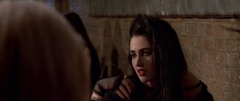 Movie still from “American Psycho” (2000), directed by Mary Harron – A person with long black hair; Close Up shot, Over the shoulder angle