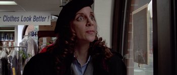Movie still from “American Psycho” (2000), directed by Mary Harron – A woman wearing a hat and looking up at the sky; Close Up shot, Low angle