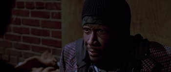 Movie still from “American Psycho” (2000), directed by Mary Harron – A person wearing a hat; Close Up shot, High angle