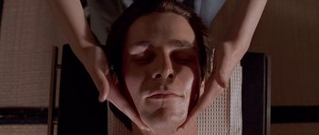 Movie still from “American Psycho” (2000), directed by Mary Harron – A man getting his face washed by a masseuse; Close Up shot, Overhead angle