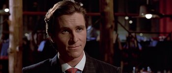 Movie still from “American Psycho” (2000), directed by Mary Harron – A person wearing a suit and tie; Close Up shot, Over the shoulder angle
