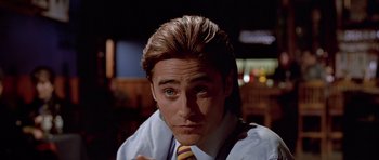 Movie still from “American Psycho” (2000), directed by Mary Harron – A person wearing a shirt and tie; Close Up shot, Over the shoulder angle