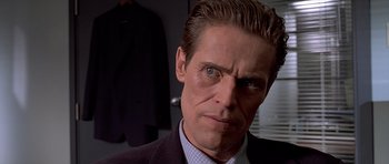 Movie still from “American Psycho” (2000), directed by Mary Harron – A person wearing a suit and tie; Close Up shot, Over the shoulder angle