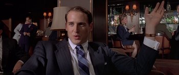 Movie still from “American Psycho” (2000), directed by Mary Harron – A man in a suit and a tie; Close Up shot, Over the shoulder angle