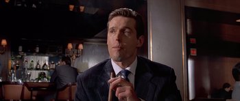 Movie still from “American Psycho” (2000), directed by Mary Harron – A person wearing a suit and tie; Close Up shot, Low angle