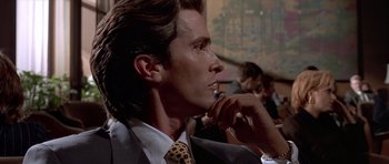 Movie still from “American Psycho” (2000), directed by Mary Harron – A person wearing a suit and tie; Close Up shot, Over the shoulder angle