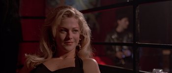 Movie still from “American Psycho” (2000), directed by Mary Harron – A beautiful blond haired woman in a black dress; Close Up shot, Low angle