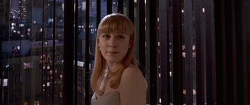 Movie still from “American Psycho” (2000), directed by Mary Harron – A woman with long blonde hair wearing a white dress; Close Up shot, Over the shoulder angle