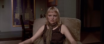 Movie still from “American Psycho” (2000), directed by Mary Harron – A woman sitting in a chair wearing a scarf; Close Up shot, High angle