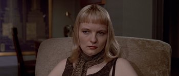 Movie still from “American Psycho” (2000), directed by Mary Harron – A person sitting on a couch; Close Up shot, Low angle