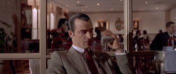 Movie still from “American Psycho” (2000), directed by Mary Harron – A man in a suit and tie holding a cell phone; Close Up shot, Low angle