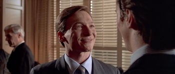Movie still from “American Psycho” (2000), directed by Mary Harron – A person wearing a suit and tie; Close Up shot, Over the shoulder angle
