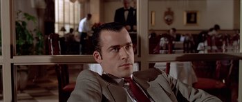 Movie still from “American Psycho” (2000), directed by Mary Harron – A person wearing a suit and tie; Close Up shot, Low angle