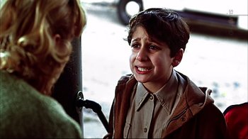 Movie still from “American Splendor” (2003), directed by Shari Springer Berman – A young boy is crying while talking to an older woman; Close Up shot, Over the shoulder angle