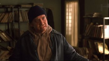 Movie still from “American Splendor” (2003), directed by Shari Springer Berman – A man wearing a hat and a leather jacket; Close Up shot, Over the shoulder angle