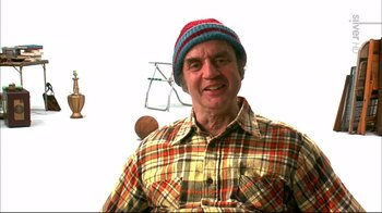Movie still from “American Splendor” (2003), directed by Shari Springer Berman – A man wearing a plaid shirt and a blue hat; Medium shot, Low angle