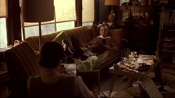 Movie still from “American Splendor” (2003), directed by Shari Springer Berman – Two people sitting on a couch in a living room; Wide shot, High angle