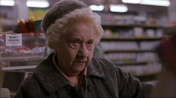 Movie still from “American Splendor” (2003), directed by Shari Springer Berman – An older woman with a hat on in a grocery store; Close Up shot, Low angle