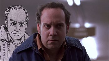 Movie still from “American Splendor” (2003), directed by Shari Springer Berman – A person wearing a jacket; Close Up shot, Low angle