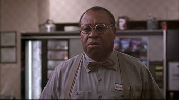 Movie still from “American Splendor” (2003), directed by Shari Springer Berman – A man wearing glasses and a bow tie in a kitchen; Close Up shot, Low angle