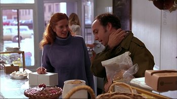 Movie still from “American Splendor” (2003), directed by Shari Springer Berman – A man and a woman standing next to each other; Medium shot, Over the shoulder angle