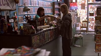 Movie still from “American Splendor” (2003), directed by Shari Springer Berman – Two people at a counter in a book store; Wide shot, Low angle