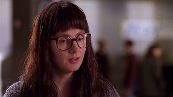 Movie still from “American Splendor” (2003), directed by Shari Springer Berman – A woman wearing glasses and looking at the camera; Close Up shot, Over the shoulder angle