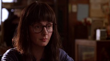 Movie still from “American Splendor” (2003), directed by Shari Springer Berman – A woman wearing glasses sitting in front of a window; Close Up shot, Over the shoulder angle