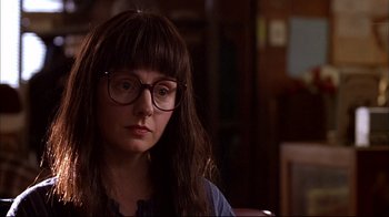 Movie still from “American Splendor” (2003), directed by Shari Springer Berman – A woman wearing glasses sitting in front of a window; Close Up shot, Over the shoulder angle
