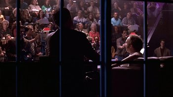 Movie still from “American Splendor” (2003), directed by Shari Springer Berman – A group of people sitting in front of an audience; Wide shot, Over the shoulder angle