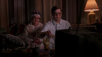 Movie still from “American Splendor” (2003), directed by Shari Springer Berman – An older woman and a young man sitting at a table; Medium shot, High angle