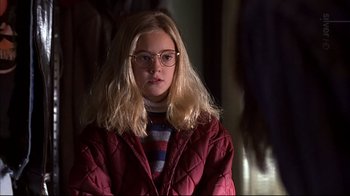 Movie still from “American Splendor” (2003), directed by Shari Springer Berman – A young girl wearing glasses and a red jacket; Close Up shot, Over the shoulder angle