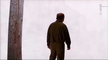 Movie still from “American Splendor” (2003), directed by Shari Springer Berman – A man standing in front of a wall with fog; Wide shot, Over the shoulder angle