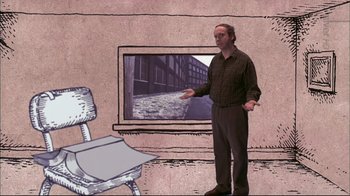 Movie still from “American Splendor” (2003), directed by Shari Springer Berman – A man standing in front of a computer screen; Wide shot, Over the shoulder angle
