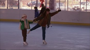 Movie still from “American Splendor” (2003), directed by Shari Springer Berman – A woman and a child are skating on the ice; Wide shot, High angle