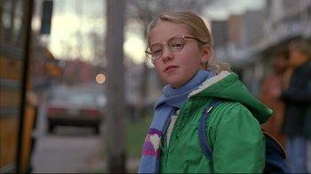 Movie still from “American Splendor” (2003), directed by Shari Springer Berman – A young girl wearing glasses and a green jacket; Close Up shot, Low angle